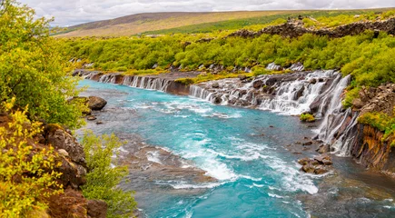 Tuinposter Hraunfossar (Borgarfjörður Iceland)  waterfalls formed by rivulets streaming out of the Hallmundarhraun, a lava field formed by a volcanic eruption. Panoramic view of popular tourist attraction. © ON-Photography
