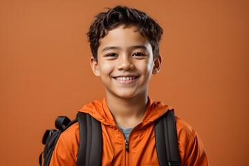 Portrait of happy schoolboy with backpack on solid orange background. Generative Ai.