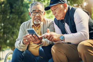 Senior men, friends and phone in park, reading and talk with memory, thinking and relax in...