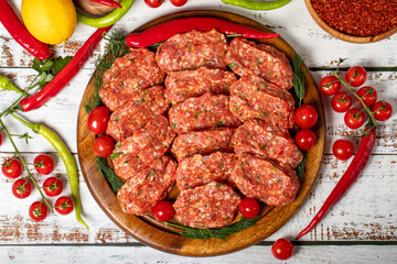 Meatballs on wood background. Raw beef meatballs with herbs and spices