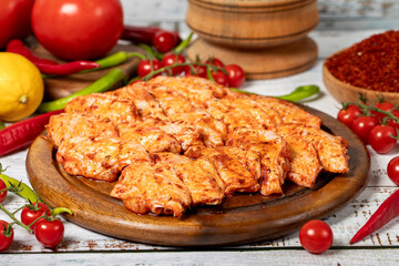 Chicken wings with sauce on wood background. Raw chicken wings with herbs and spices