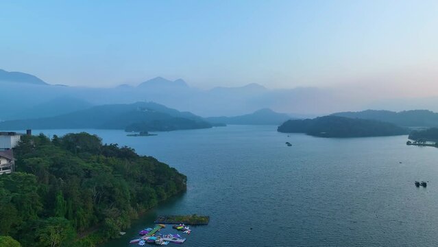 Foggy morning at a misty lake with a drone view of Sun Moon Lake