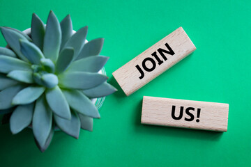 Join us symbol. Concept word Join us on wooden blocks. Beautiful green background with succulent...