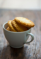 Delicious and crispy coconut cookies placed in a tea cup. Beautiful Food photography of biscuits or cookies.