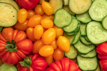 Mixed fresh vegetable background. Healthy eating ingredients. Slice of mix veggies, tomatoes, cucumbers, cherry tomato, eggplant. Nutrition, diet, vegan food. Assorted fruits rotating view closeup