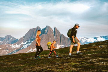 Family hiking in mountains active vacations outdoor parents and child traveling in Norway healthy...