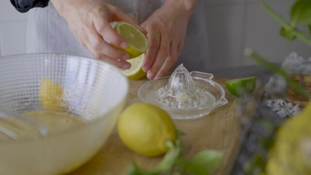 Crop woman squeezing lemon with manual squeezer