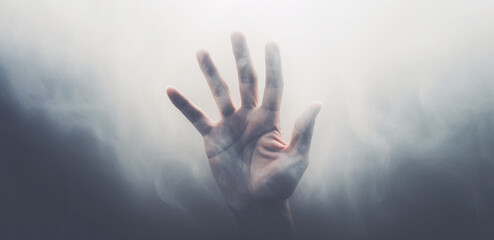 Blurry hands from fog, reaching out for something.