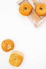 Homemade baked bread bagels on wooden board. Healthy breakfast background
