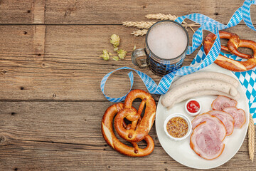 Traditional Oktoberfest set. Pretzels, beer, weisswurst, eisbein with mustard. German festival food
