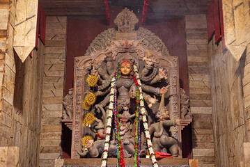 Idol of Goddess Devi Durga at a decorated puja pandal in Kolkata, West Bengal, India. Durga Puja is...