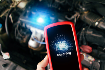 Car engine scanning with wireless technical tool, OBD2 scanner tool in a mechanic hand with a car...