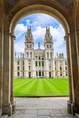 Entrance All Souls College Oxford, a constituent college of the University of Oxford in England, showing spacy courtyard with green grass. Selective focus with focus in the college