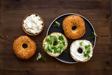 Homemade baked bread bagels with cheese cream. Healthy breakfast background