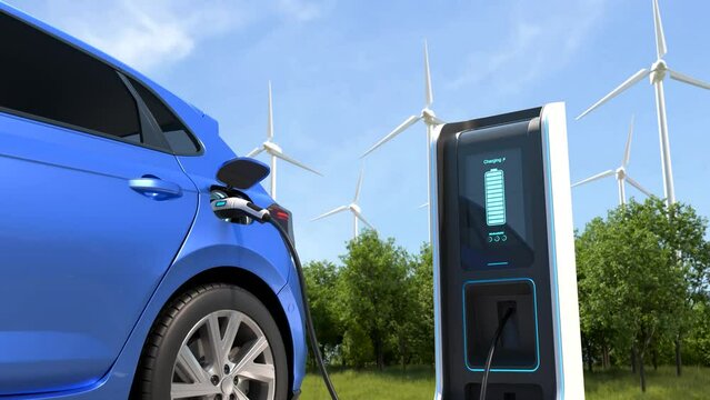 Electric cars Charging at the charging station and with a Wind turbine background, Electric power is an alternative fuel