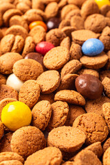 Dutch holiday Sinterklaas background with pepernoten and traditional colorful sweets strooigoed. Selective focus