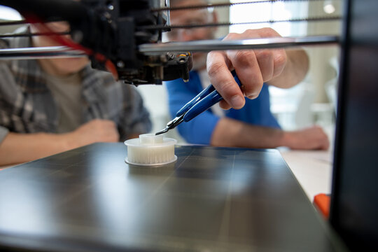 Designer working with 3D printer creative lab.