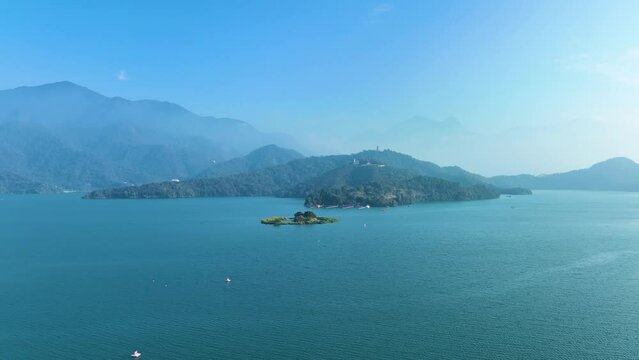 Foggy morning at a misty lake and island with aerial view in Sun Moon Lake Taiwan