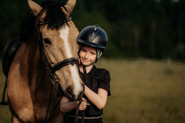 Portrait of a young jockey with a horse, horse riding training, a boy stroking a horse, a lesson for a young jockey in an equestrian school or club, pet - obrazy, fototapety, plakaty