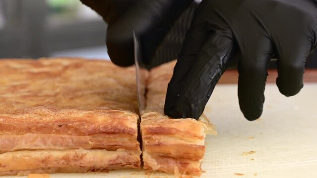 Chef cutting Kut or Kurt Borek on white cutting board