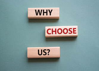 Why choose us symbol. Concept words Why choose us on wooden blocks. Beautiful grey green background. Business and Why choose us concept. Copy space.