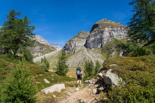 A woman hiking in the Italian Alps in the summer.