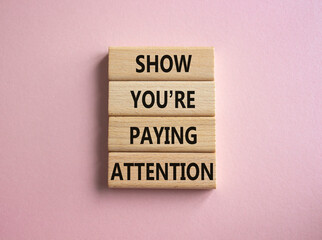 Attention symbol. Concept word Show You are Paying Attention on wooden blocks. Beautiful pink background. Business and Show You are Paying Attention concept. Copy space