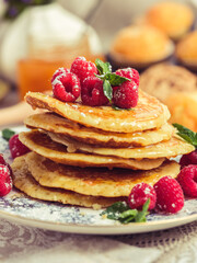 Pile of sweet pancakes with berries and honey