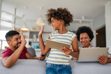 Obsessed to tech devices happy african american family using digital tablet, computer, smartphones