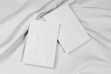 Two blank paper sheet cards with mockup copy space on glossy silk cloth. 3D rendering