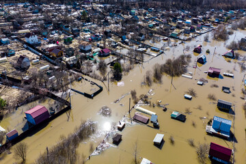 Aerial view of summer cottages flooded during the spring flood located in the lowland - obrazy, fototapety, plakaty