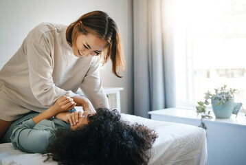 Home, lesbian and couple with love, bed and funny with bonding, marriage and relax together. Queer people, women and girls with happiness, relationship and care with trust, lgbtq and humor on a bed