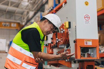 Senior male worker serious accident machine hand clamp injury in industry workplace need emergency...