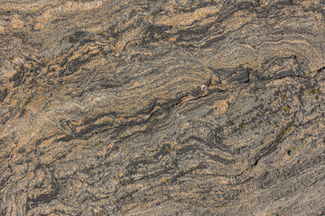Granite structure with wavy lines and small line breaks. Background pattern natural stone with brown gradient. light and dark spots in the stone due to weathering