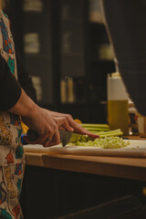 A woman cutting up a selery