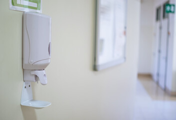 Image of disinfectant gel dispenser on hospital wall as antiviral and bacterial