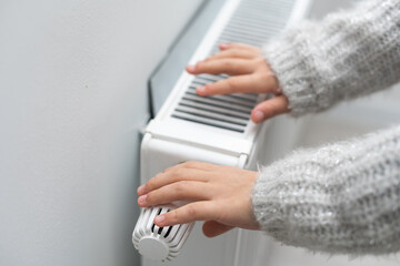Children's hands warm on the radiator.