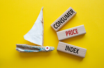 Consumer Price Index symbol. Concept words Consumer Price Index on wooden blocks. Beautiful yellow...