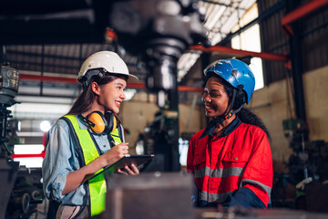 Chief Engineer and Project Manager Wearing Safety Vests and Hard Hats, Use Digital Tablet Computer...