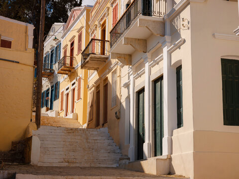 Symi Island, Greece islands holidays from Rhodos in Aegean Sea. Colorful neoclassical houses in bay of Symi. Holiday travel background. beautiful narrow street from the hill among cute Greek houses