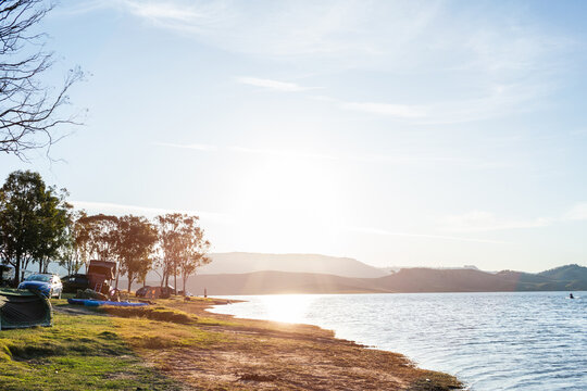 Campground at edge of lake in afternoon light