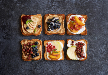 Sweet toasts made from fresh berries, jam, peanut butter and honey. Healthy toasts made from berries and fruits