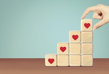 Increasing customer concept. Wooden cubes with red heart