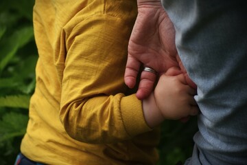 Child holding Mother's hand