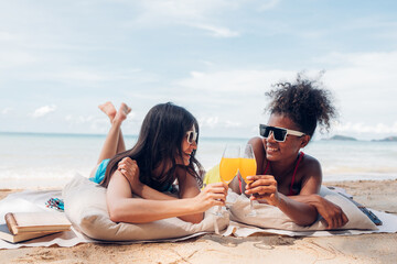 Happy beauty woman in bikini sitting and drinking together on the beach having fun in a sunny day, Beach summer holiday sea people concept.