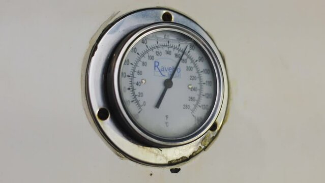 Pressure gauge in a factory, arrow movement on an industrial pressure gauge. Industrial pressure gauge