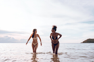 Happy beauty woman in bikini walking and playing together on the beach having fun in a sunny day, Beach summer holiday sea people concept.