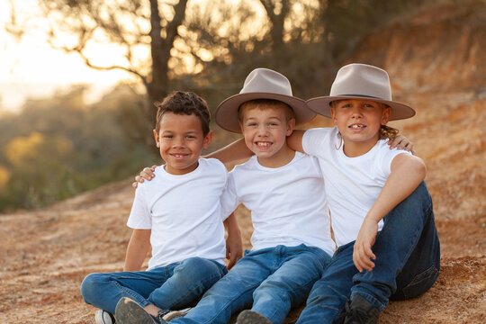 Portrait of three happy Aboriginal brothers in rural country setting