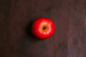 red apple on a beautiful wooden base