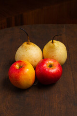 red pears and apples on a wooden base